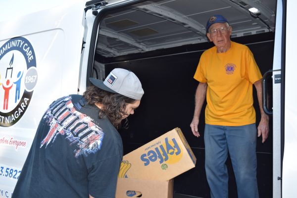Lion John Burton unloads some boxes with the help of Noah Bennett.