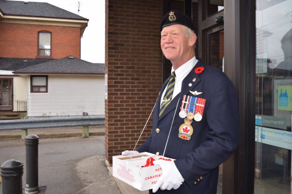 Barry Stark canvassing poppies at an Ontario St. storefront in Beamsville