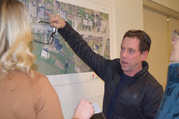 A man points to a map that details plans for road reconstruction.