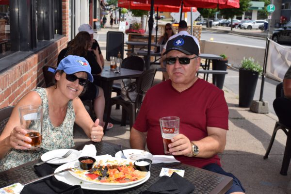 A woman and her husband eat lunch on an outside patio.